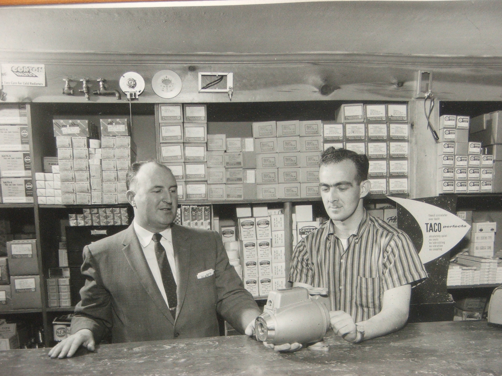 Company founder John F. White (left) and John E. Fogerty holding an early model Taco circulator.